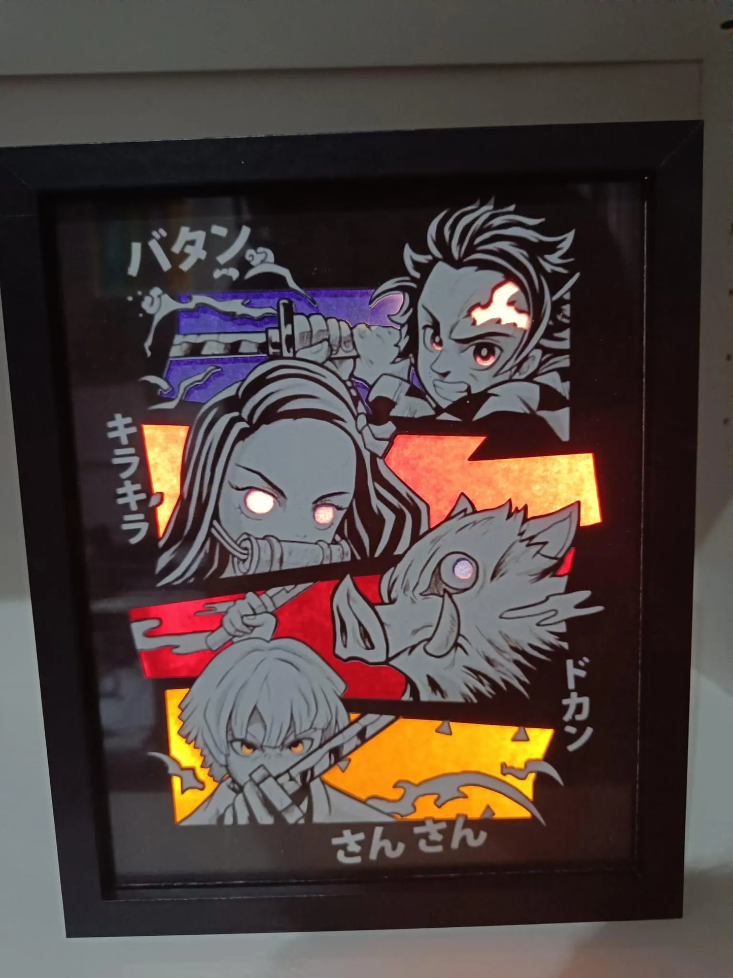 Dettaglio frontale della cornice Demon Slayer con personaggi in stile chibi